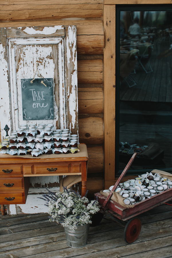 Jam jar wedding favor table with rustic and vintage detail - wedding photo by Michigan-based wedding photographers Bryan and Mae
